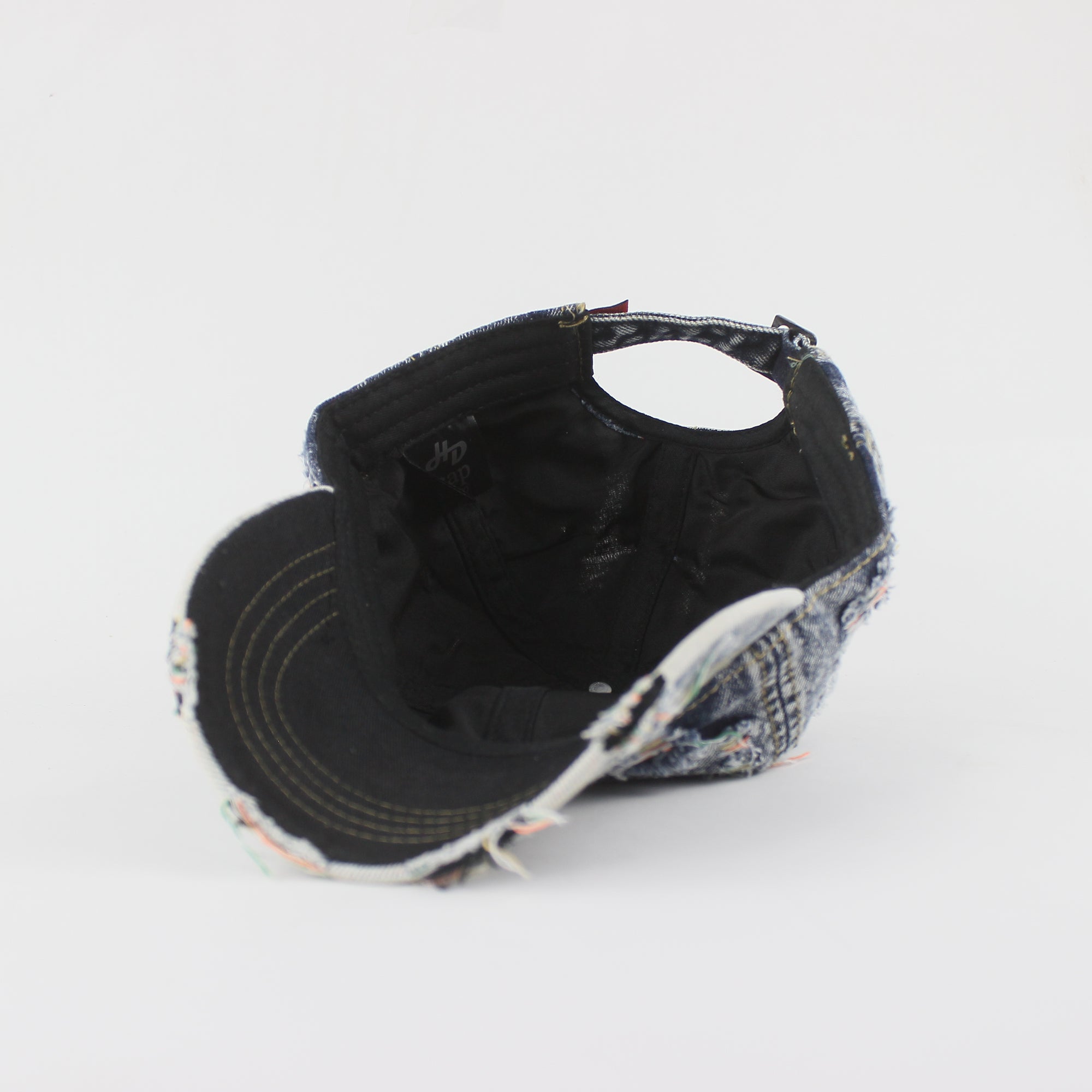 Black and patterned cap on a light gray background