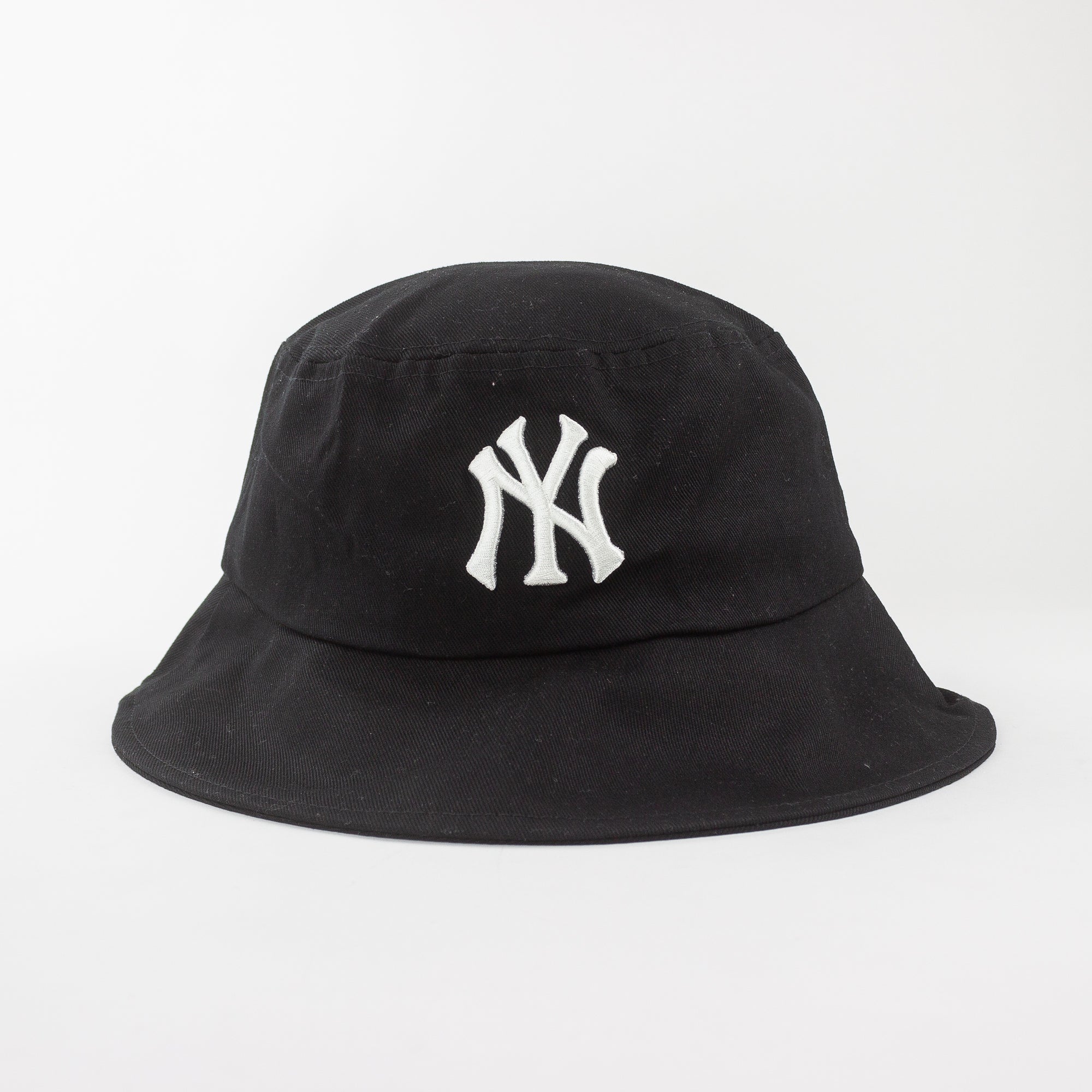 Black bucket hat with white logo on a light gray background