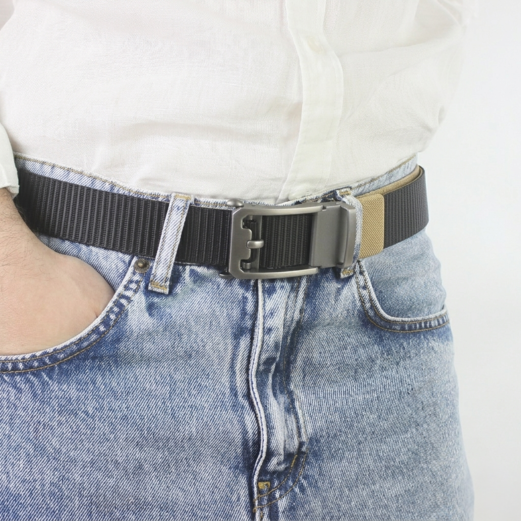 Close-up of a man wearing a black and yellow textured nylon belt with light wash denim jeans and a white linen shirt.